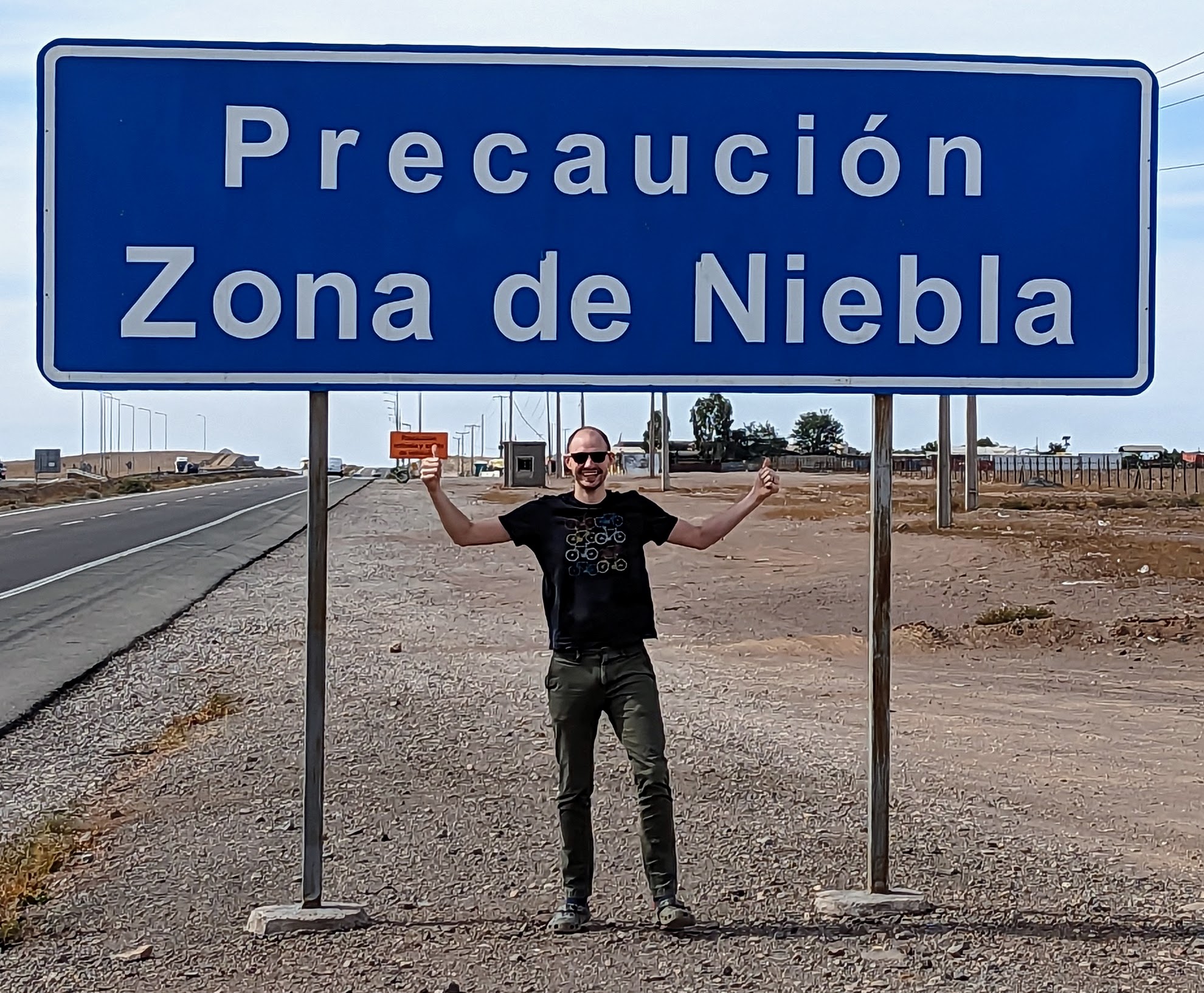 Man standing in front of sign